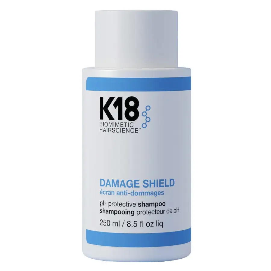 K18 Damage Shield pH Protective Shampoo 250ml flaske med blått og hvitt design for hårbeskyttelse.